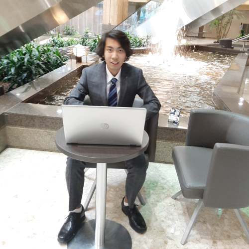 Henry Tsang - Calgary SEO consultant sitting with his computer
