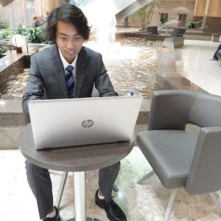 Calgary Local search expert Henry Tsang working on his laptop in a office space
